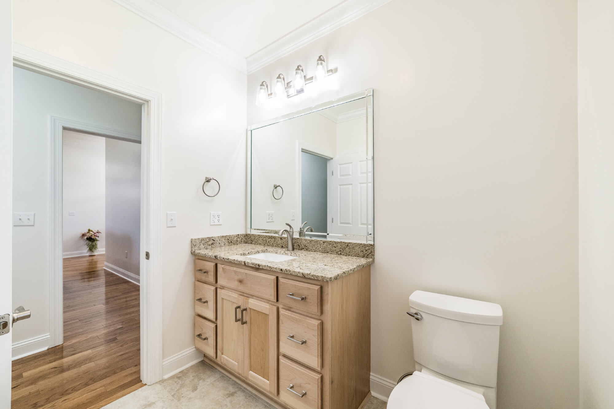 Custom wood vanity with granite top in bathroom