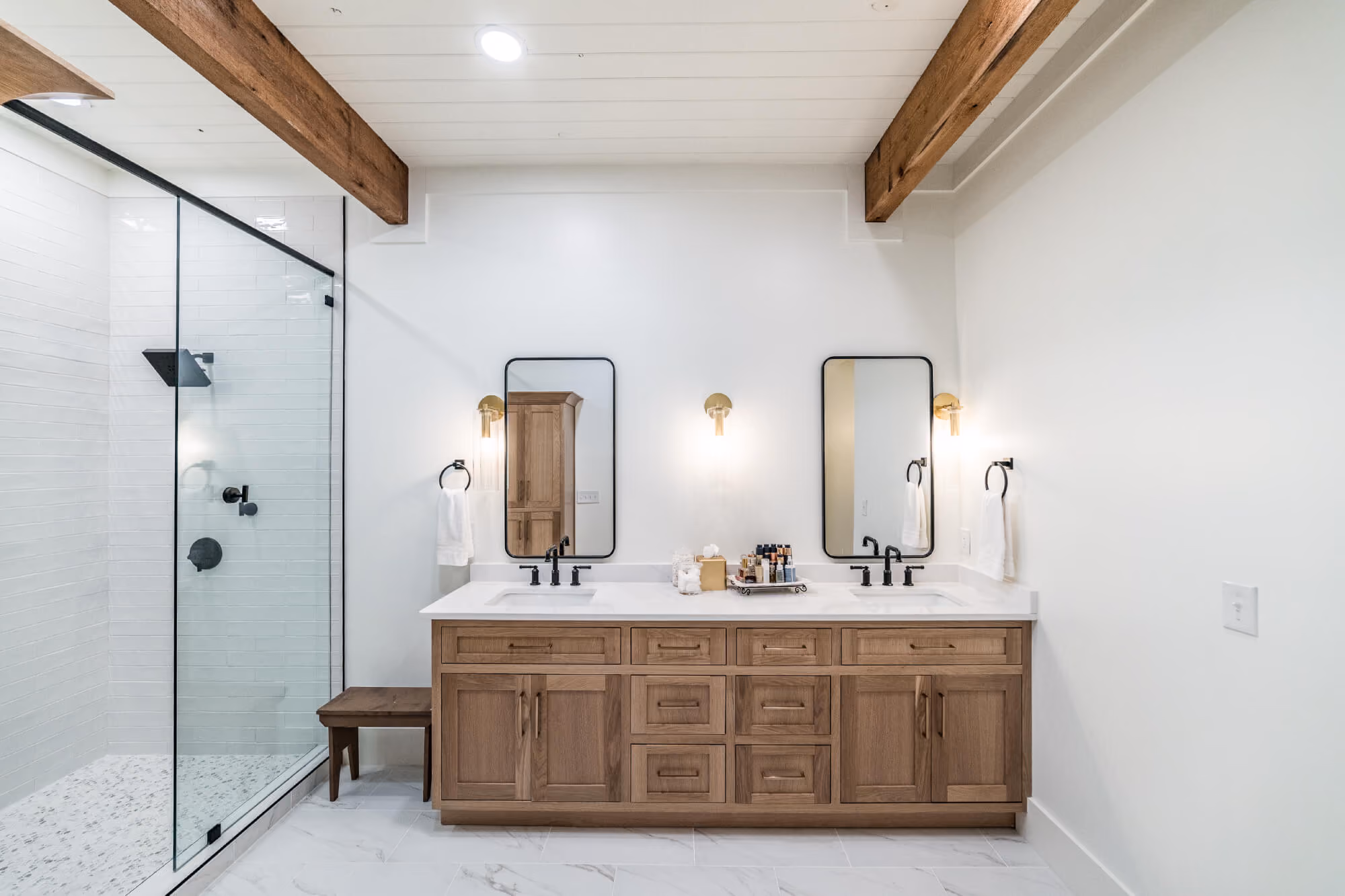 Rustic bathroom vanity with wall-mounted mirrors and lighting