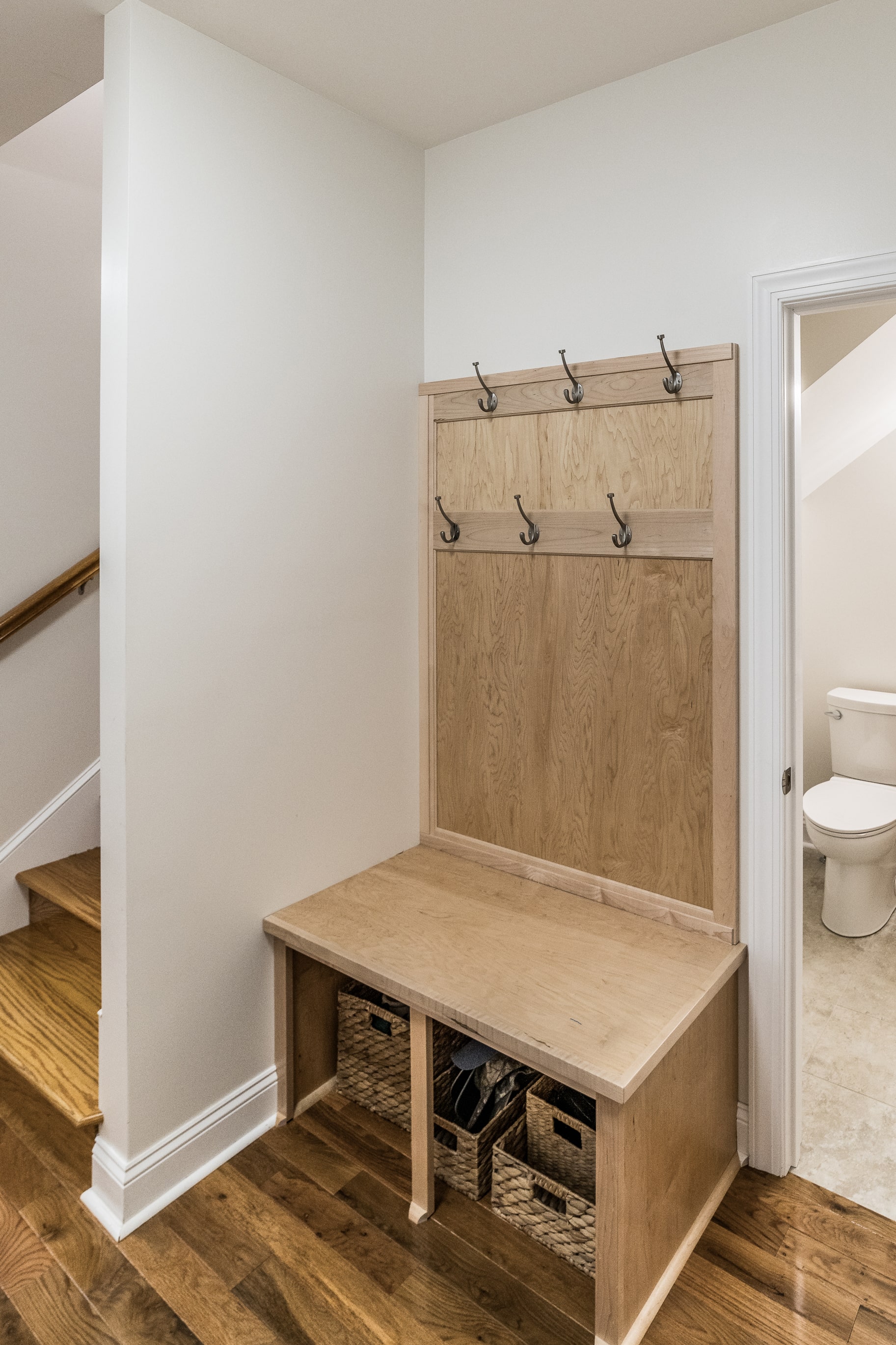 Mudroom cabinetry with bench and coat hooks