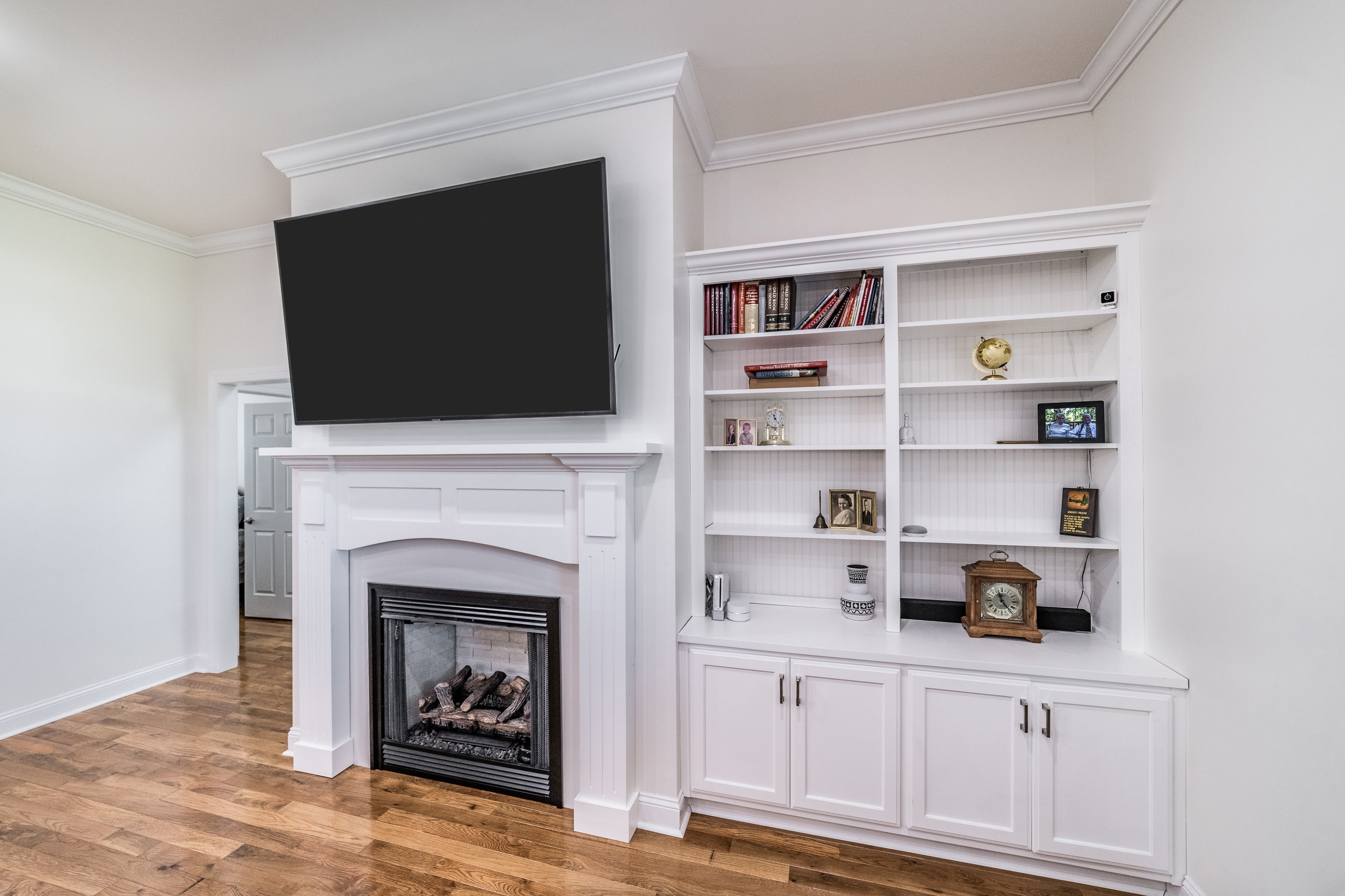 Living room with custom bookshelf cabinetry and fireplace
