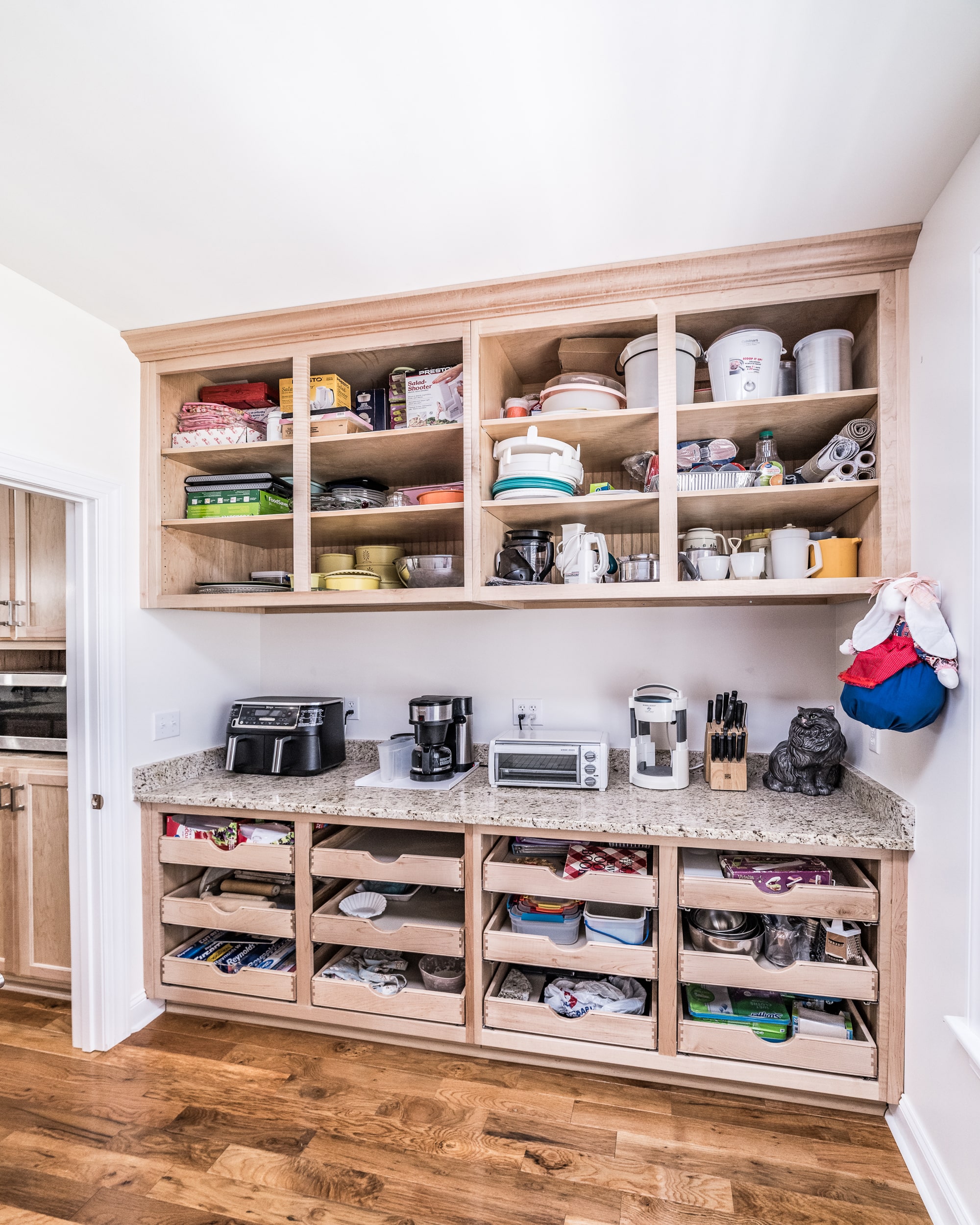 White pantry cabinets with drawers and open shelving