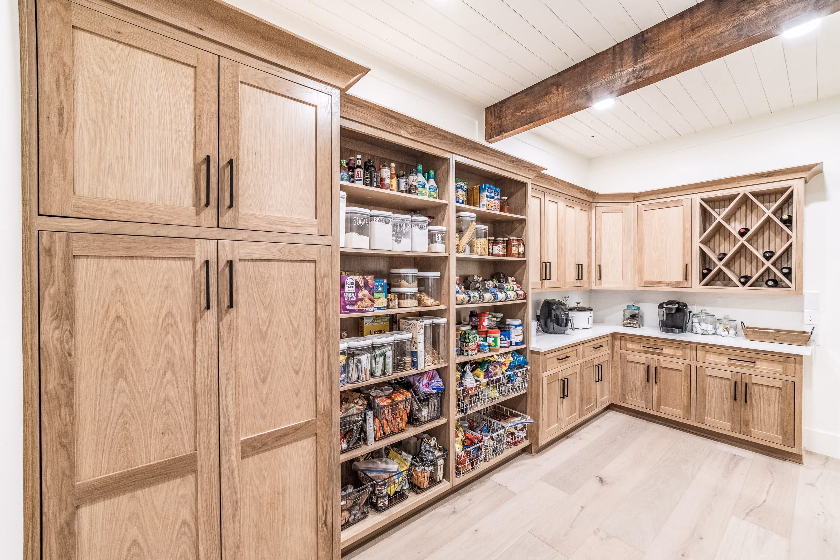 Walk-in pantry with natural wood custom cabinetry