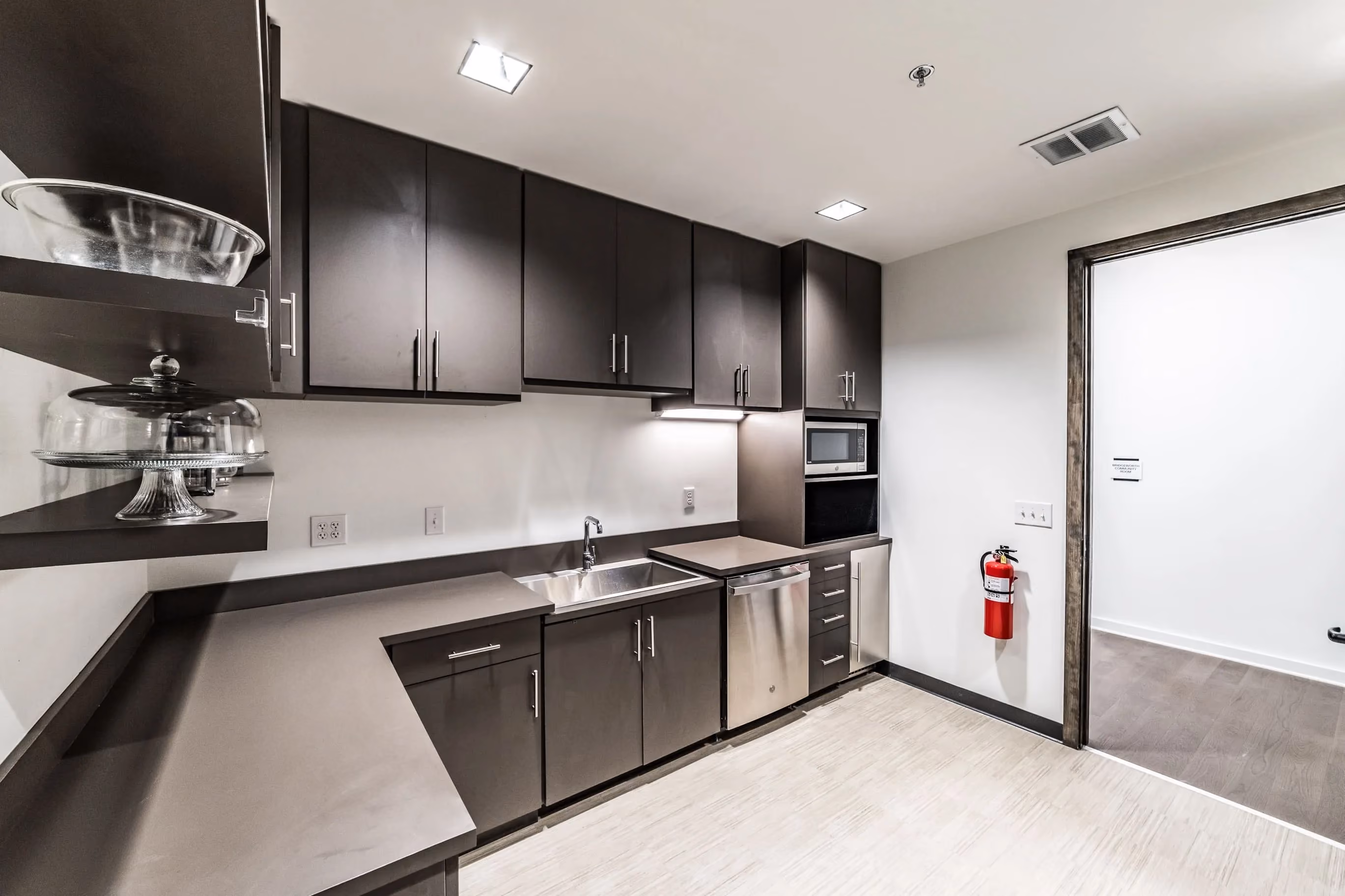 Breakroom cabinetry with upper storage and built-in microwave