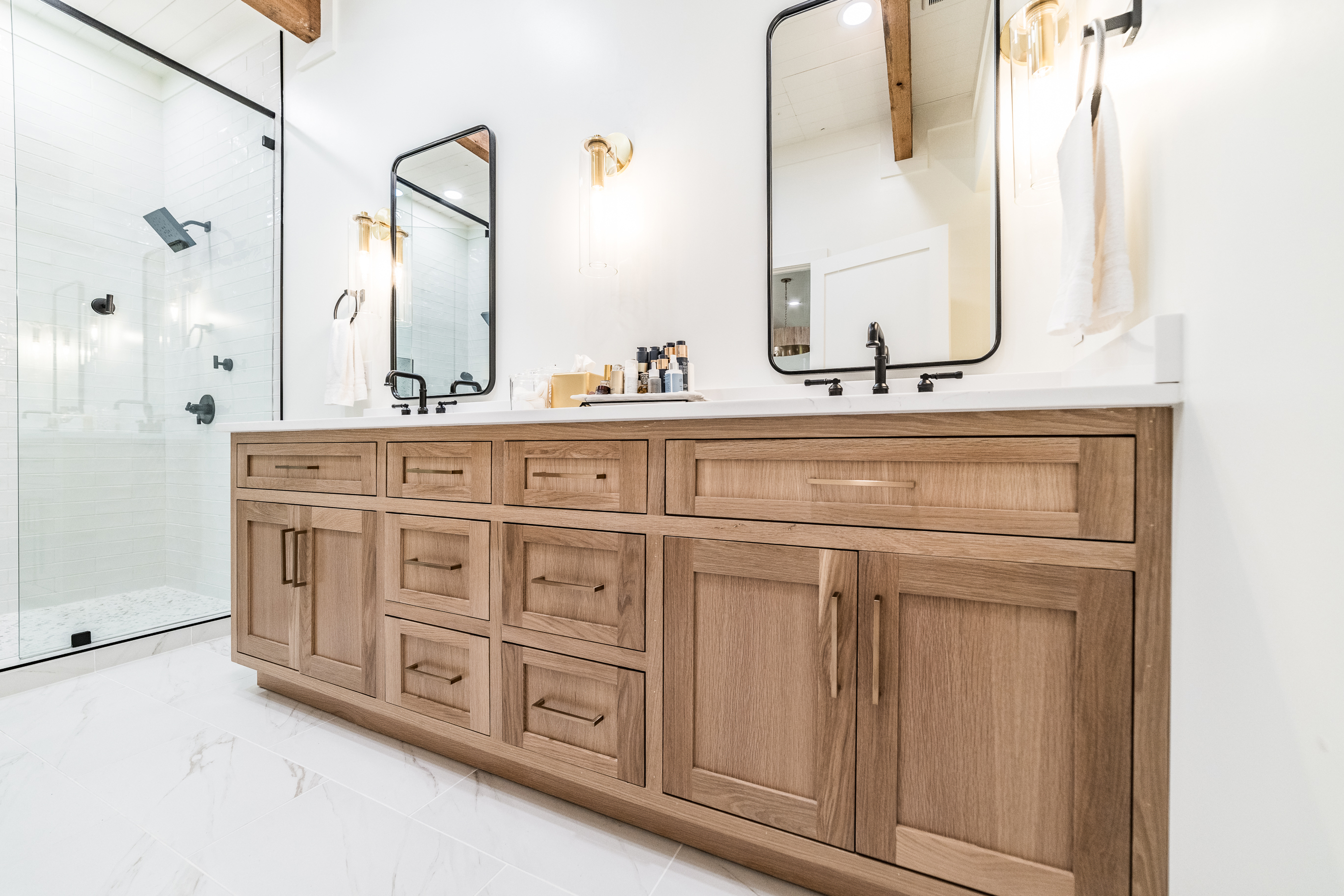 Natural wood bathroom cabinets with wide drawers and vessel sinks