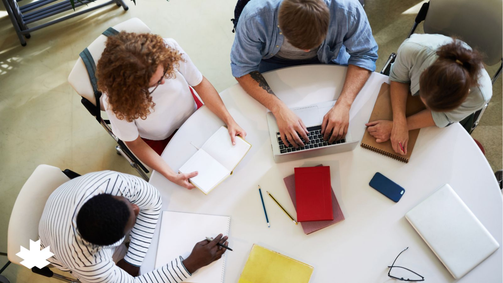 Overhead view of people working together at a table.