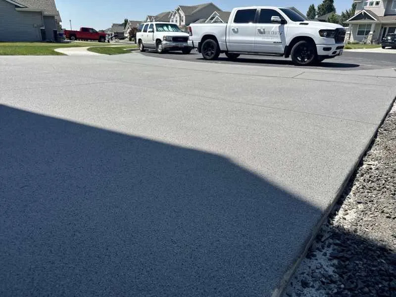 Homeowner resurfacing a driveway in Spokane, highlighting DIY home improvement