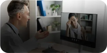 A man looking at a picture of a woman on a computer screen.