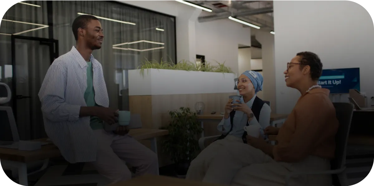 A group of people sitting around a table talking.