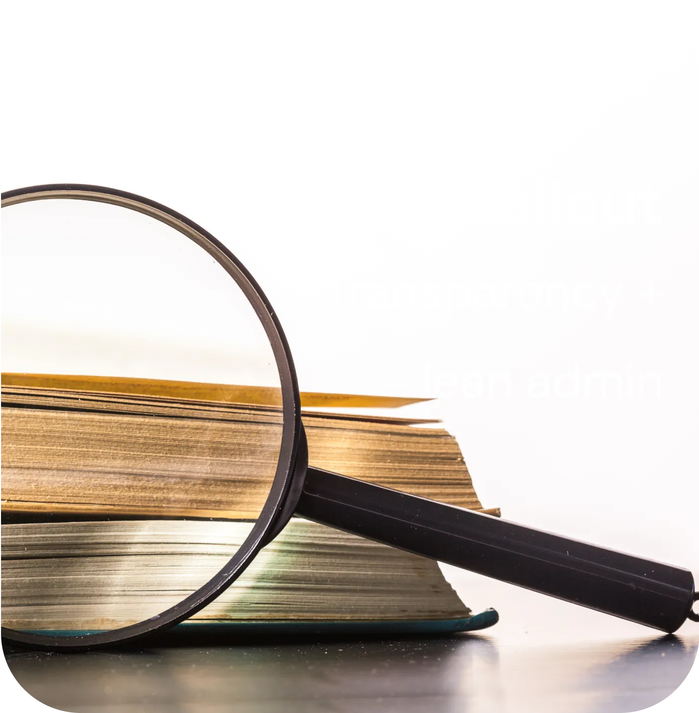 A magnifying glass sitting on top of a pile of books.