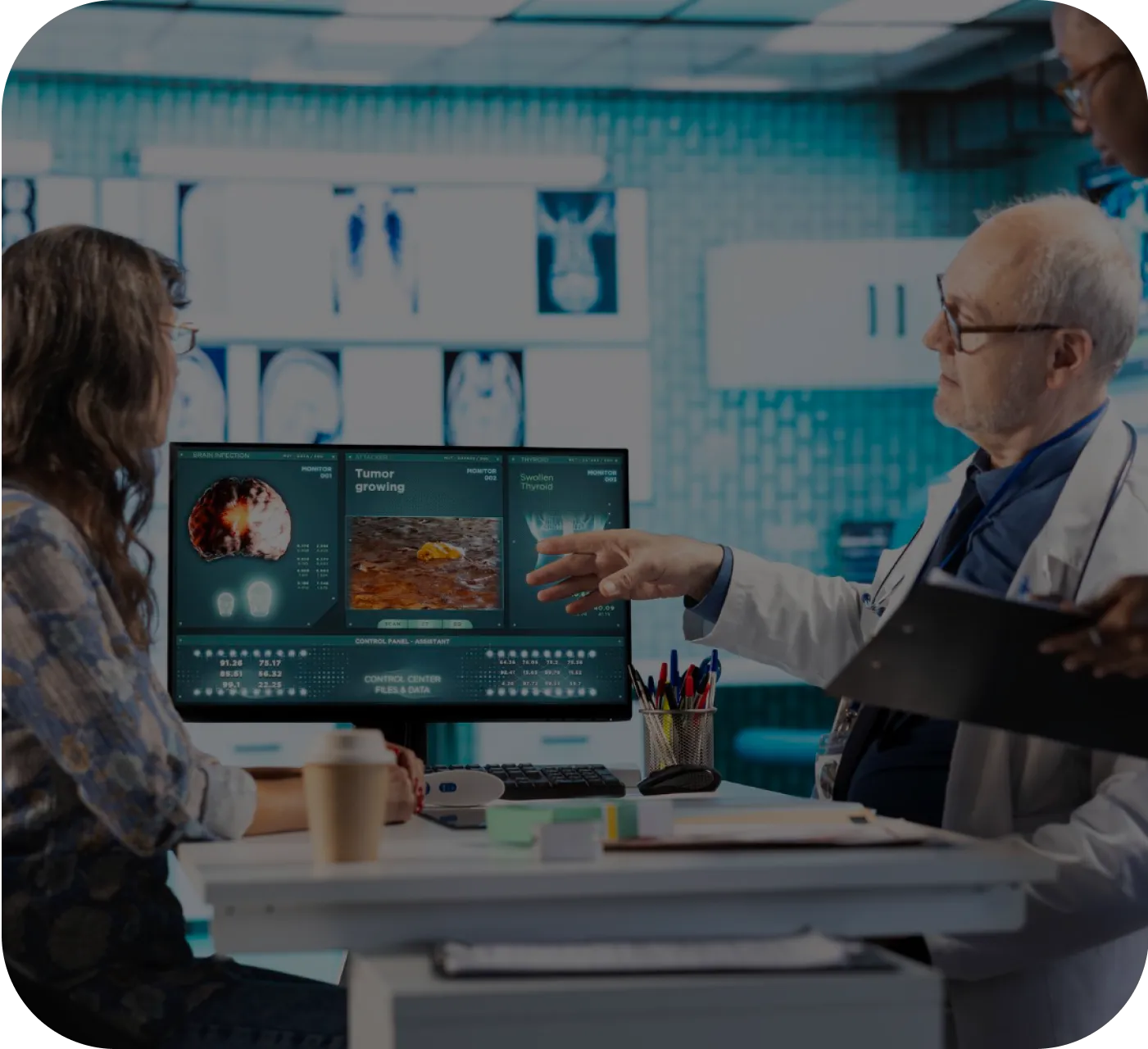 A man and a woman sitting at a desk in front of a computer screen.