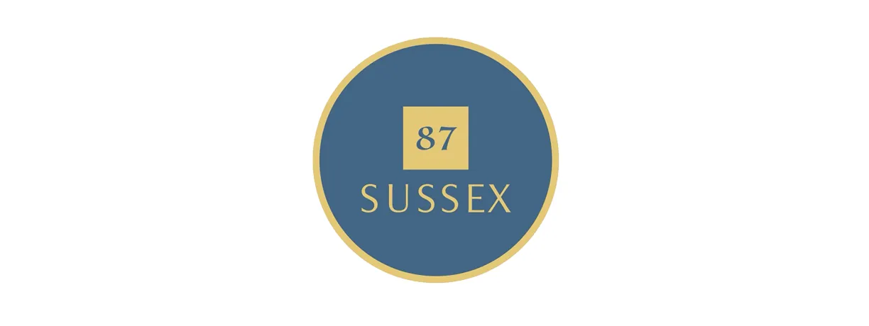A blue oval with a gold border and the words sussex on it.