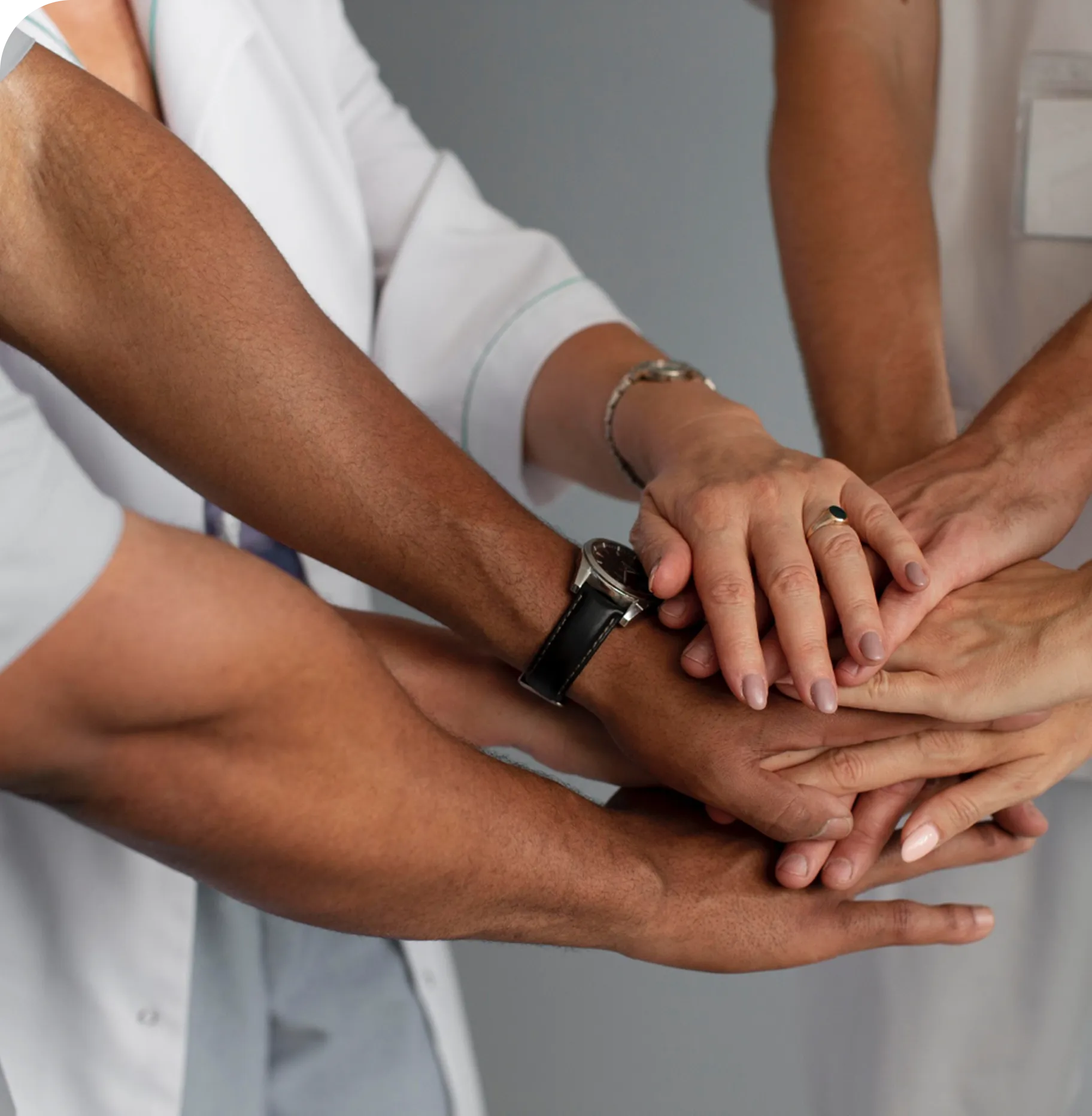 A group of people putting their hands together.