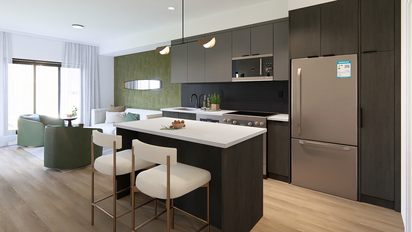 Contemporary apartment kitchen with dark cabinetry, quartz countertops, and stainless steel appliances. An island with bar seating overlooks a bright living room with green accent chairs and a white sectional.