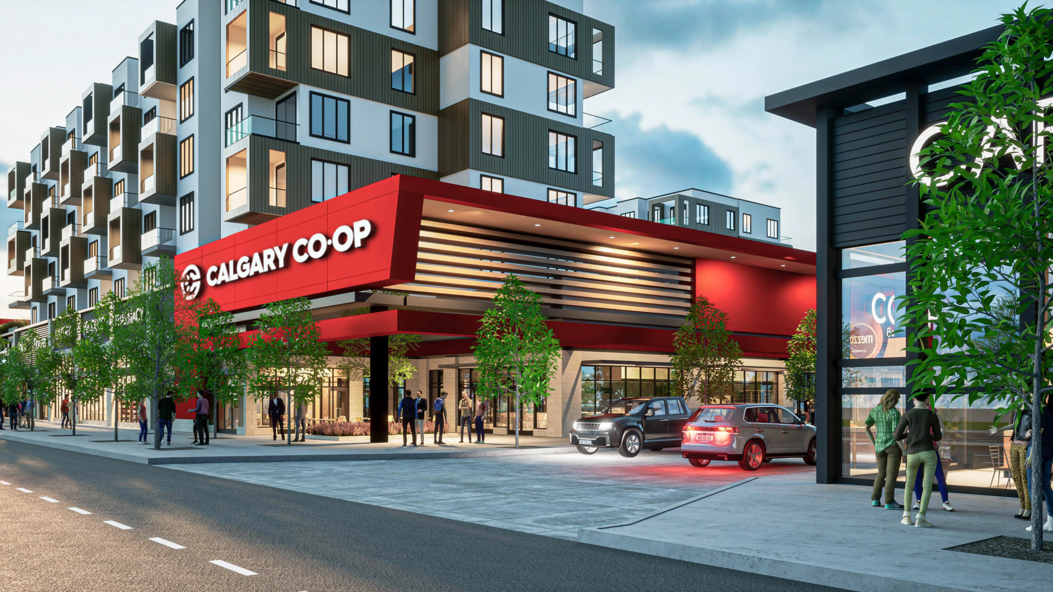 Street-level view of Munro’s mixed-use development featuring the Calgary Co-op grocery store at the base, with residential units above. Modern architecture with stacked balconies and pedestrian-friendly sidewalks.