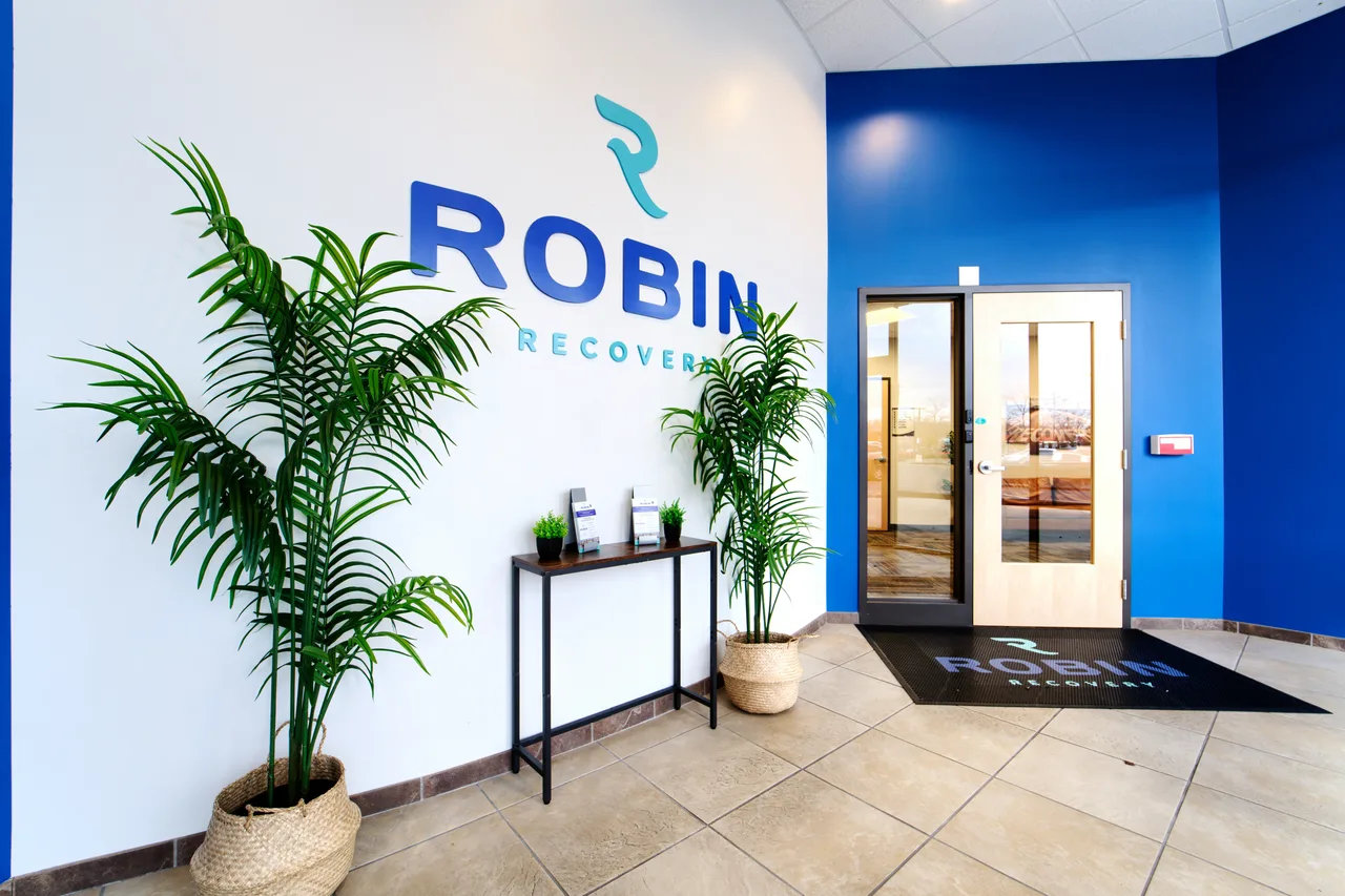 Robin Recovery entrance in Whitehall with blue branding and indoor plants