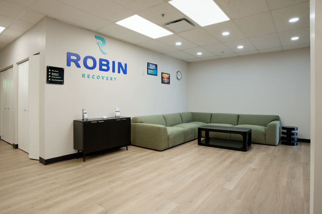 Reception lounge with green seating and Robin Recovery branding at the Cleveland facility in Independence