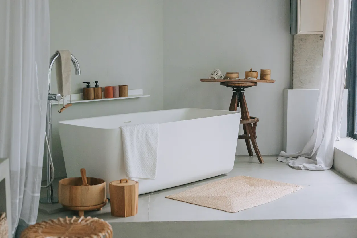 Elegant bathroom featuring freestanding soaking tub, classic tile finishes, natural light, and timeless design details in Ontario