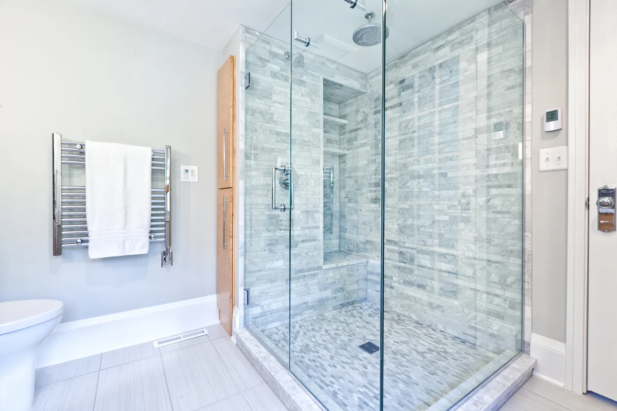 Luxury bathroom renovation with custom walk-in shower, marble tile walls, frameless glass enclosure, and spa-like design in Ontario
