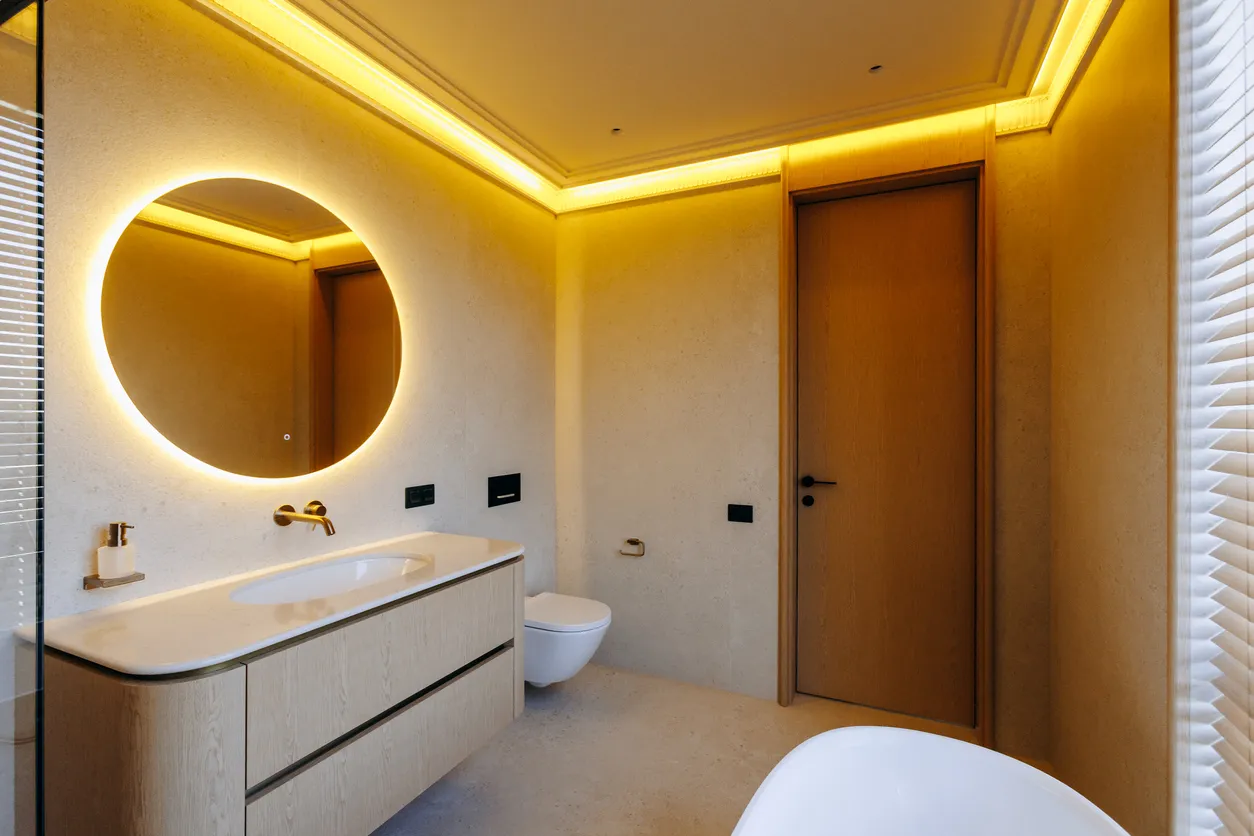 High-end bathroom with radiant floor heating, custom LED lighting scheme, gold fixtures, and comfort upgrades in Ontario by Leo Constra