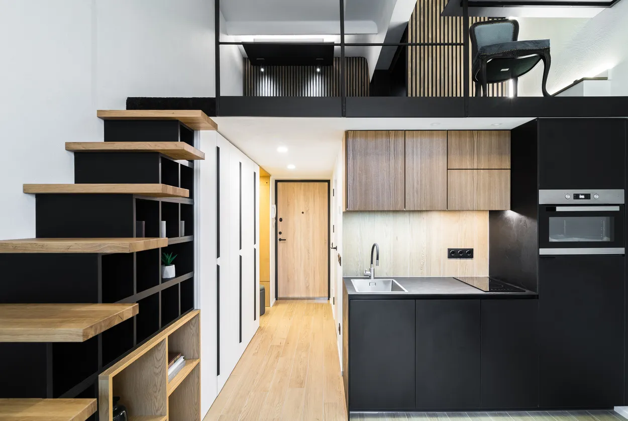 Modern condo renovation with custom open layout, built-in shelving, black cabinetry, and efficient kitchen design in Ontario by Leo Constra