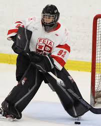 Falcons goalie Demitry Gikas in his FEIA jersey and goalie gear on the ice