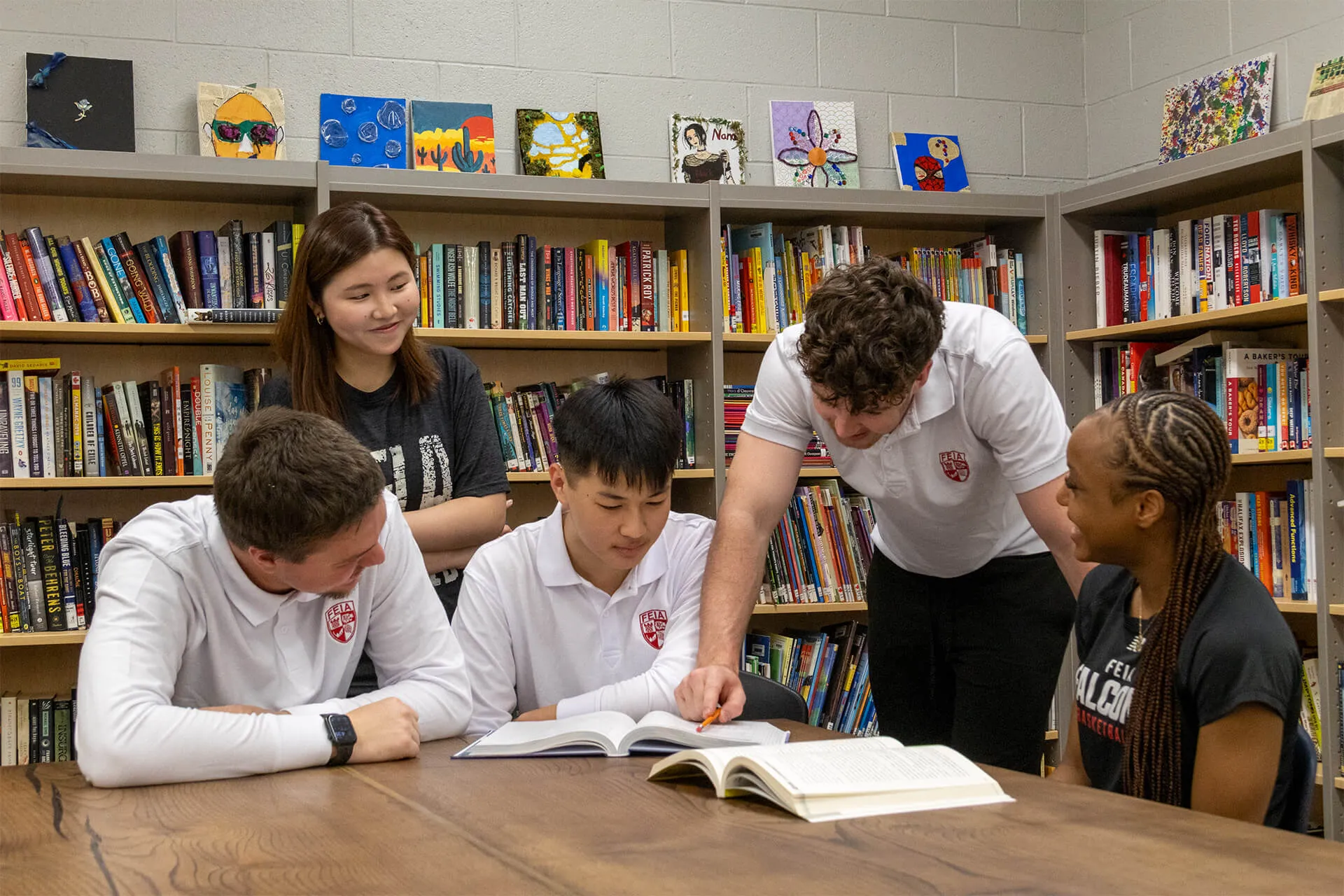 FEIA students in uniform studying together around a table in the library