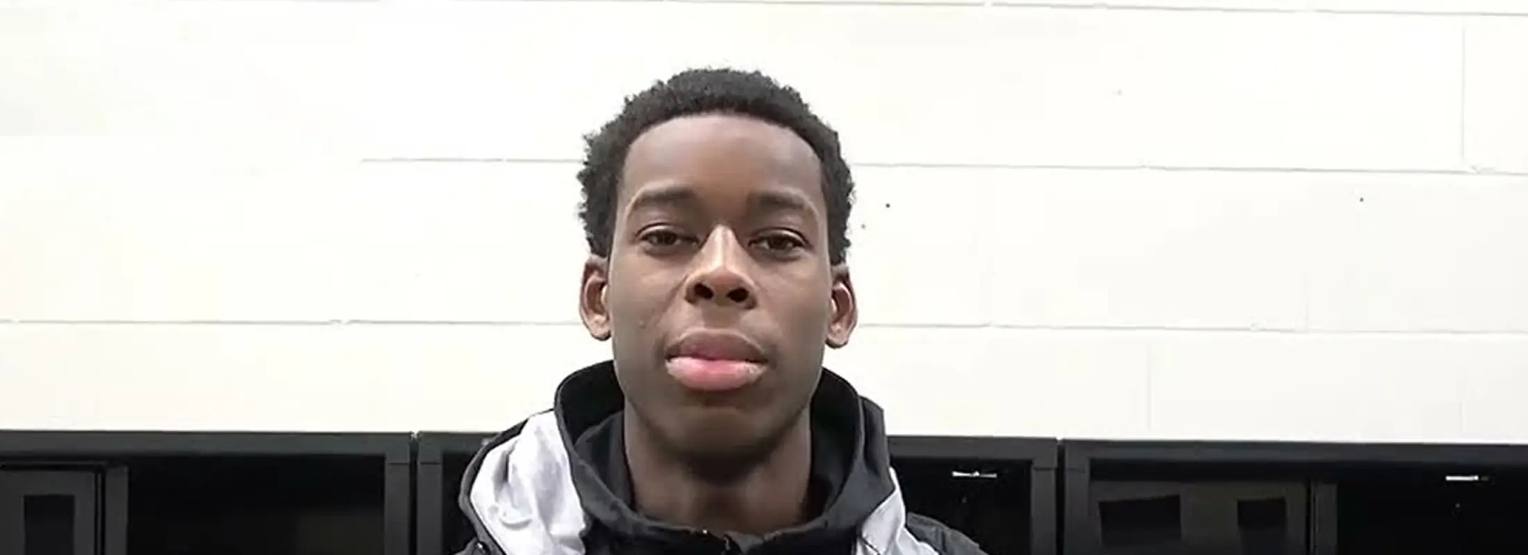 Portrait of a young FEIA basketball player in a grey zip hoodie