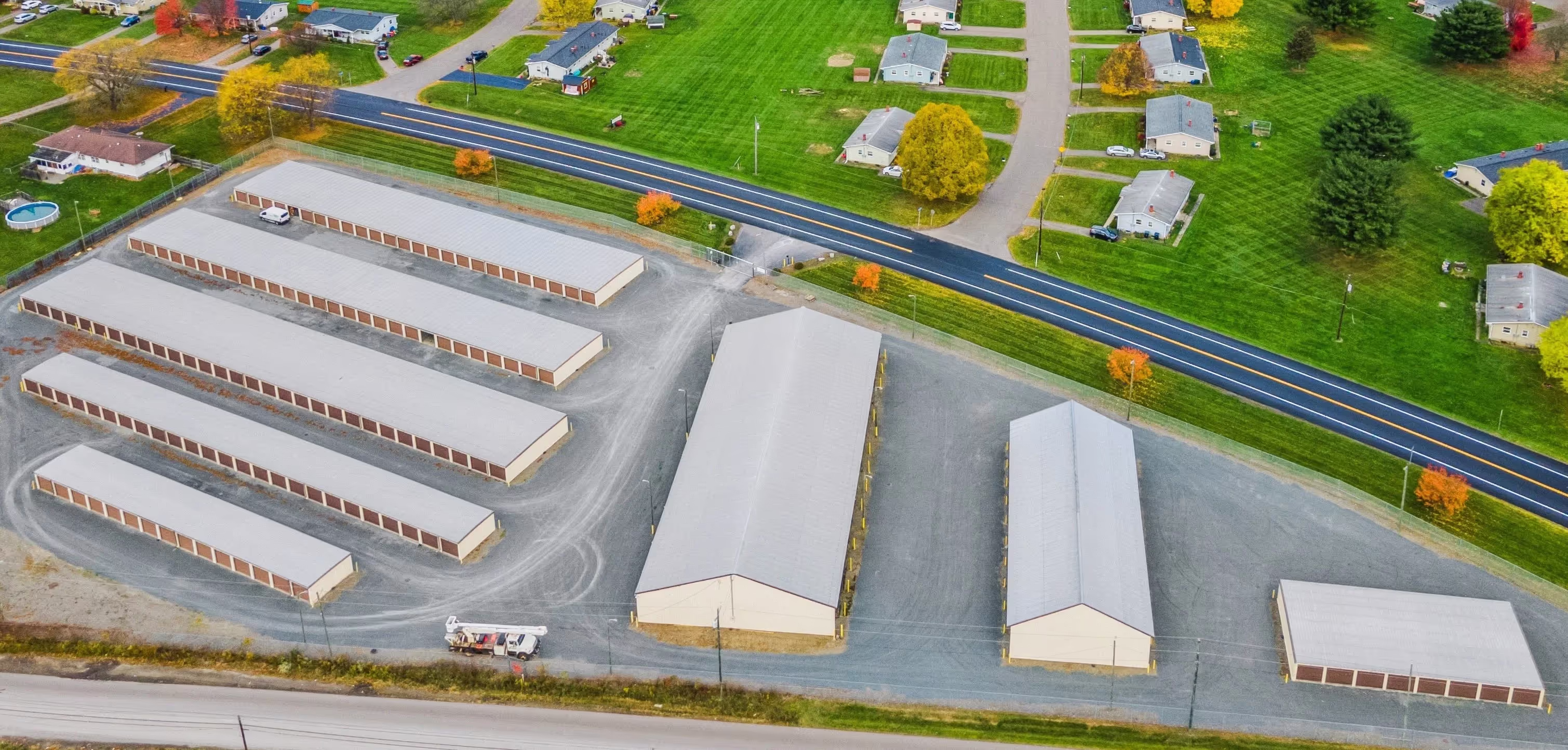 Aerial photo of Bolt Storage in Elmira, New York with rows of drive-up storage units beside a main road.