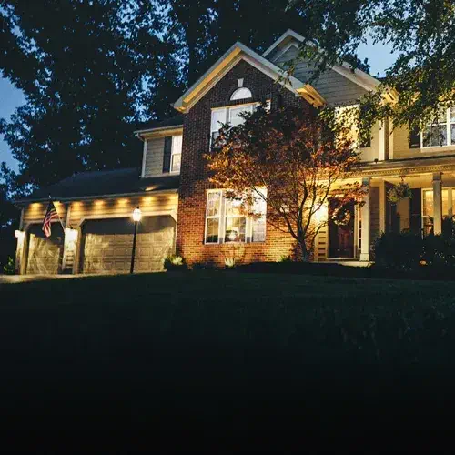 House at night with the best landscape lighting setup for a beautifully illuminated yard in Rose Valley, PA