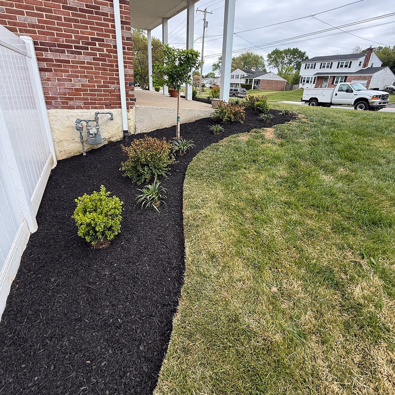Fresh mulch installation improving curb appeal by E&J Landscaping