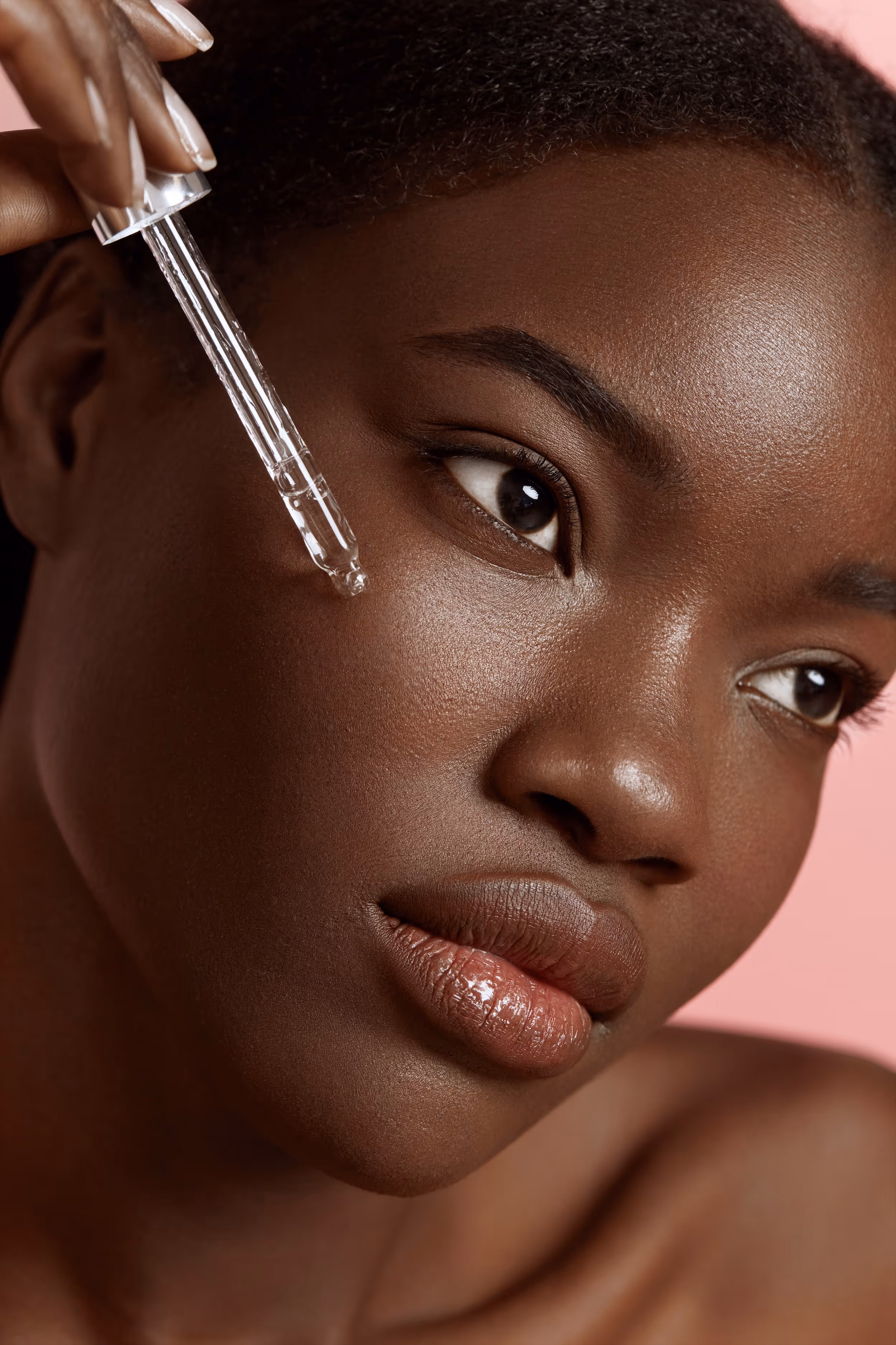 Woman putting on skin care stock image