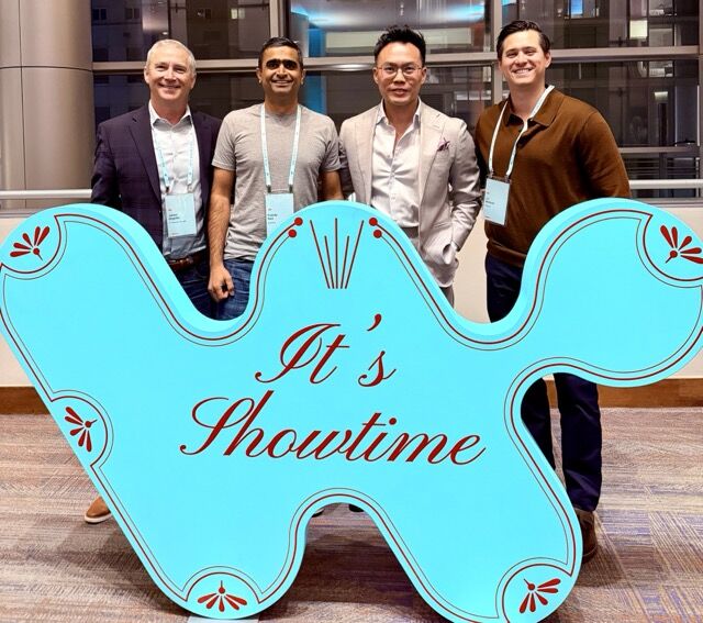 OneSolve team members at the Workato SKO event stage in Denver