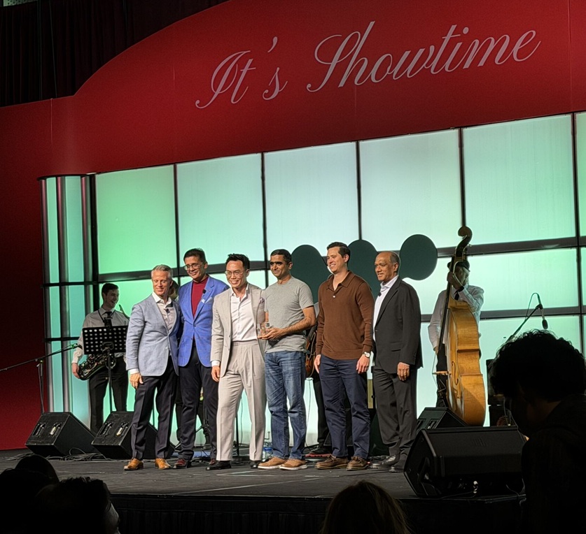 OneSolve team receiving the North America Innovation Partner of the Year award on stage at the 2026 Workato Partner Awards in Denver
