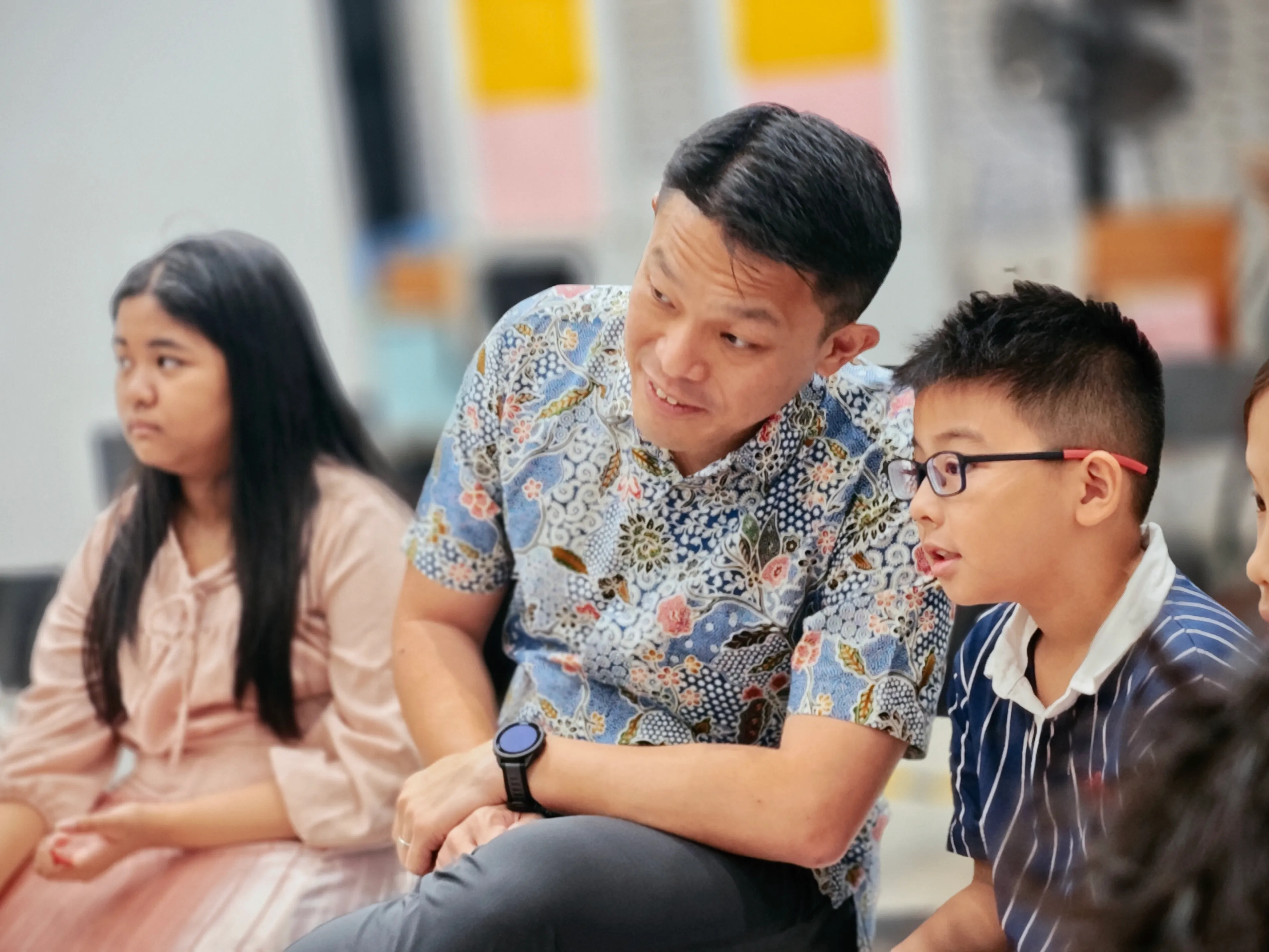 Coach guiding students during a communication skills activity
