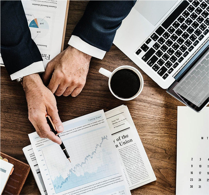 Business professionals reviewing printed financial reports