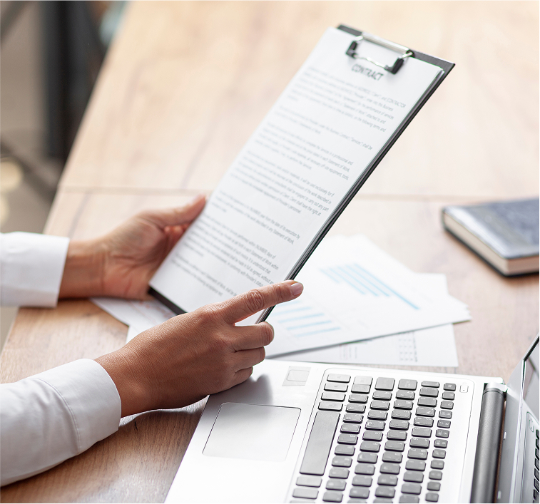 Hands holding clipboard with printed document