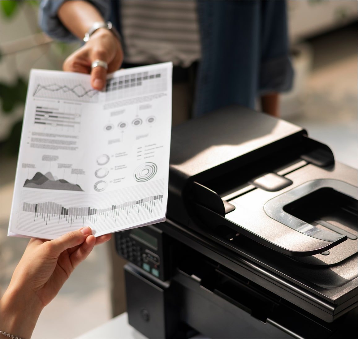 Office worker scanning paper into copier machine