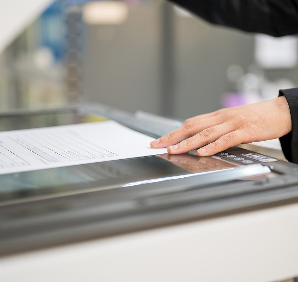 Hands operating a professional document scanner