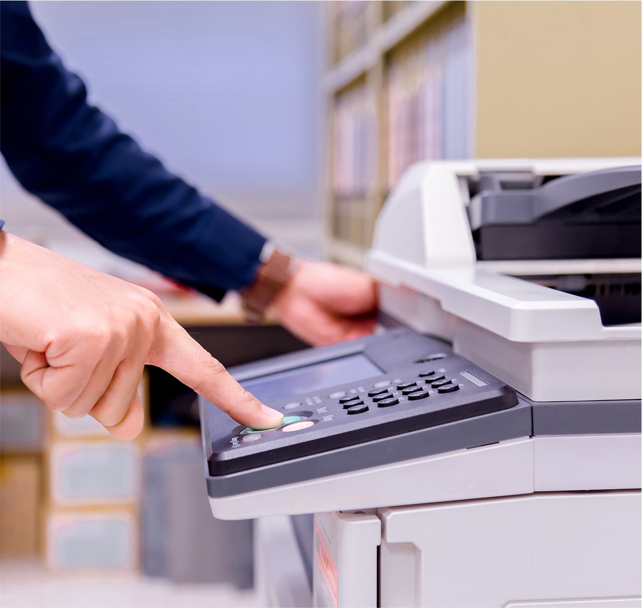 Office worker scanning paper document at copier machine