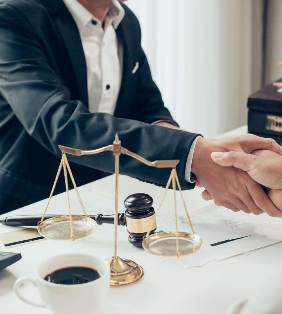 Business handshake at law firm office with legal documents