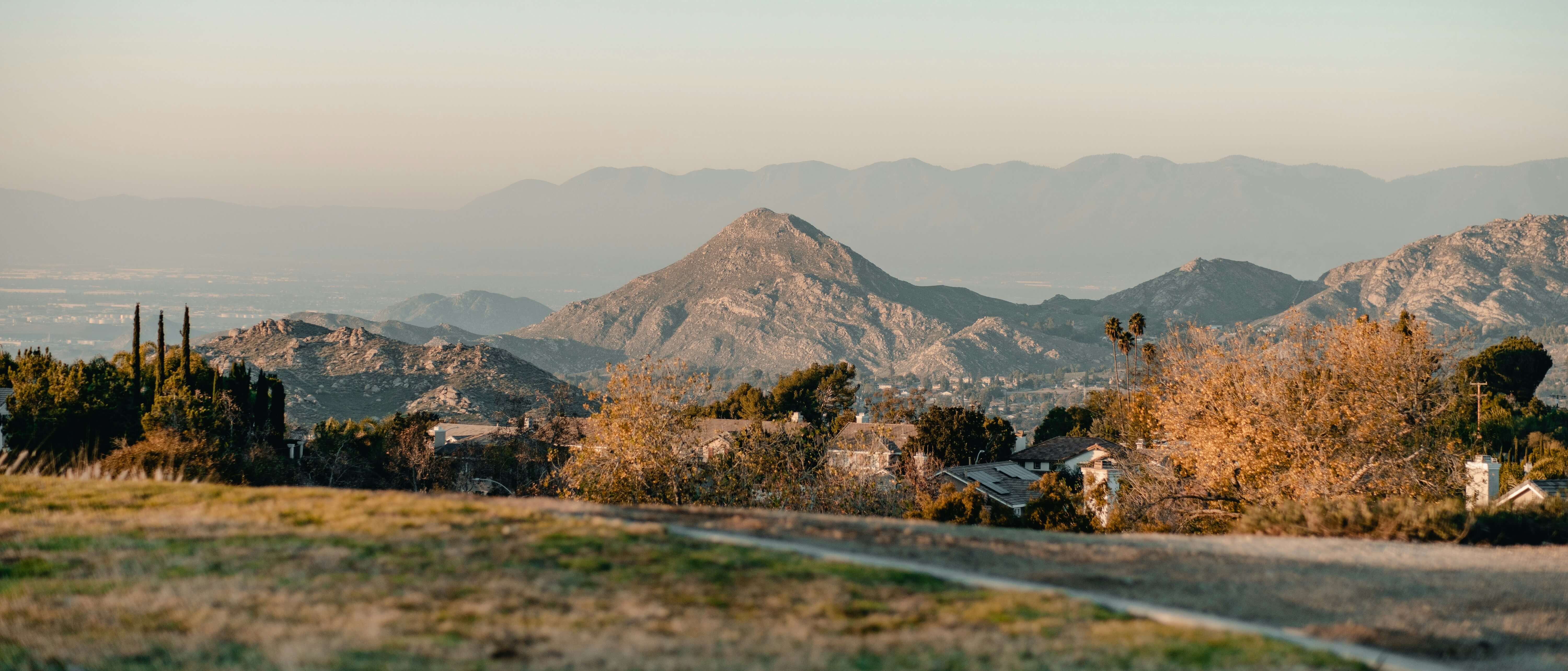 Picture of riverside with sprawling mountains in the foreground