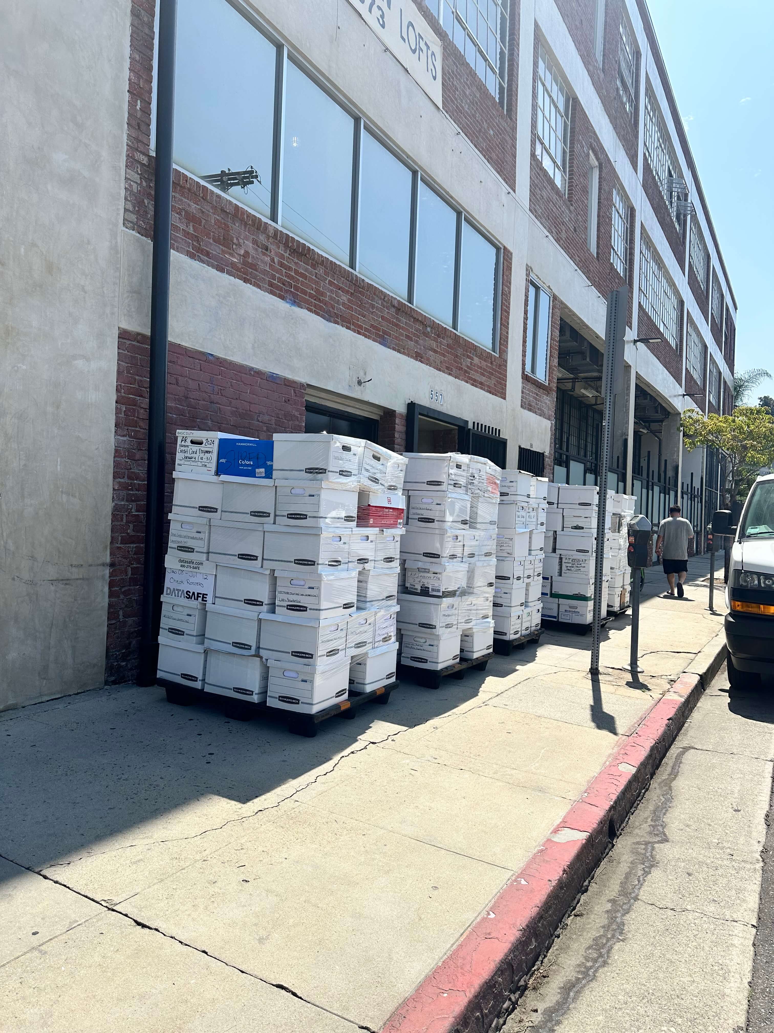 Pallets of document storage boxes staged for secure shredding and recycling