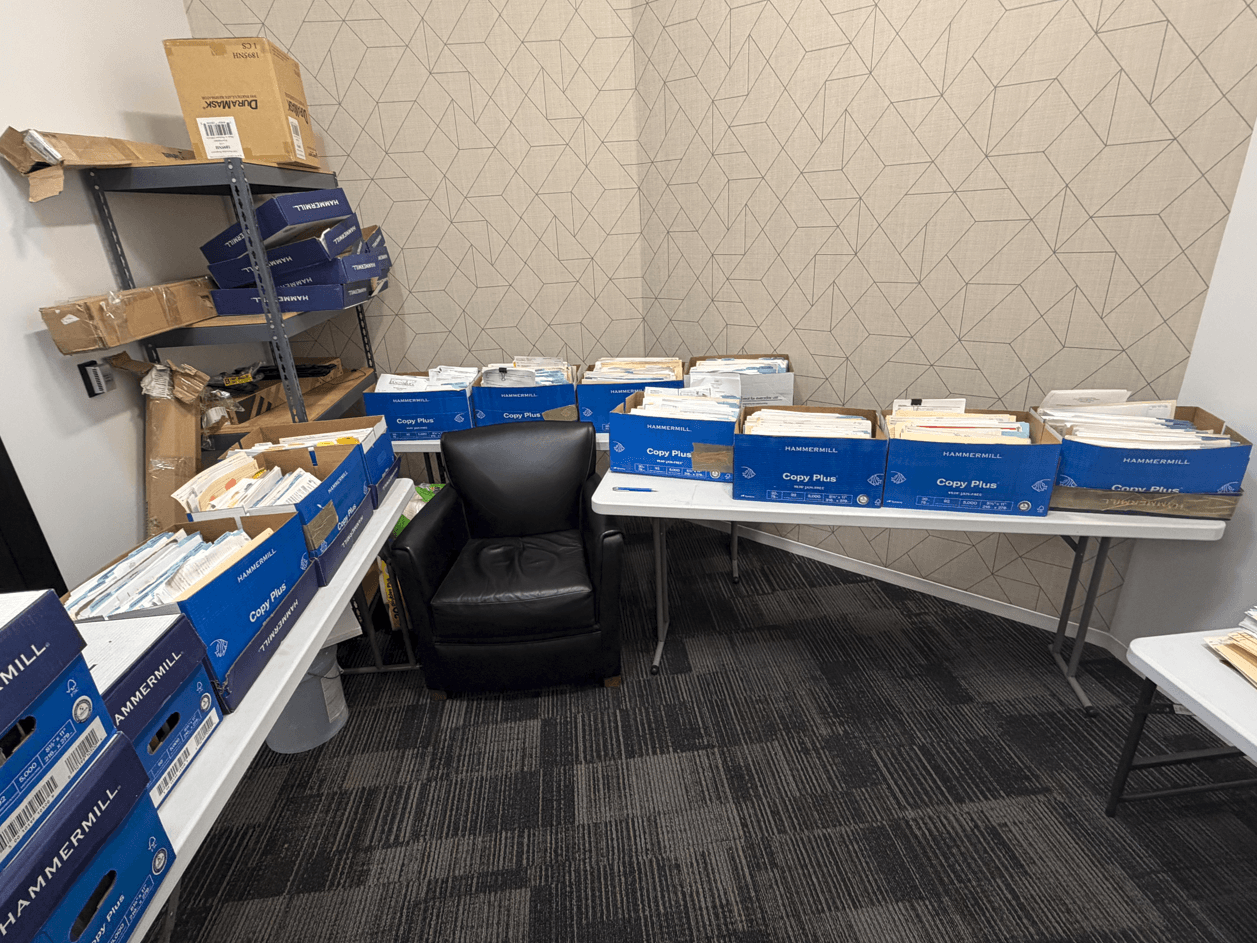 Stacks of paper business records waiting to be scanned and digitized