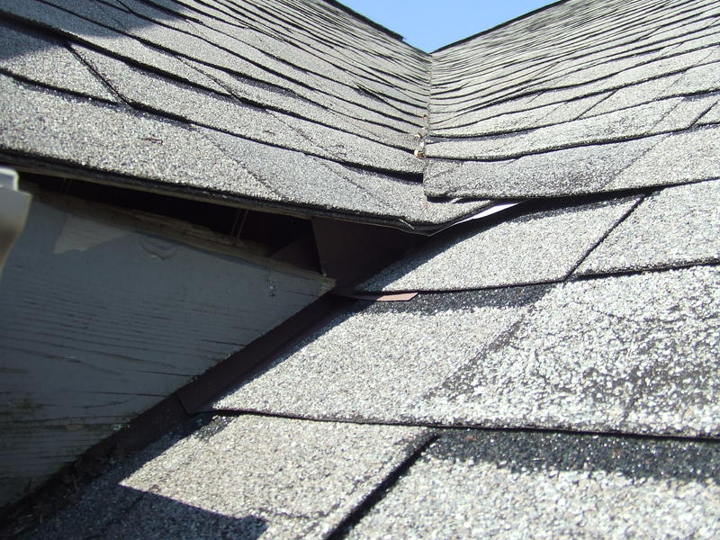 Old tired asphalt shingles showing roof drying and wear in Calgary