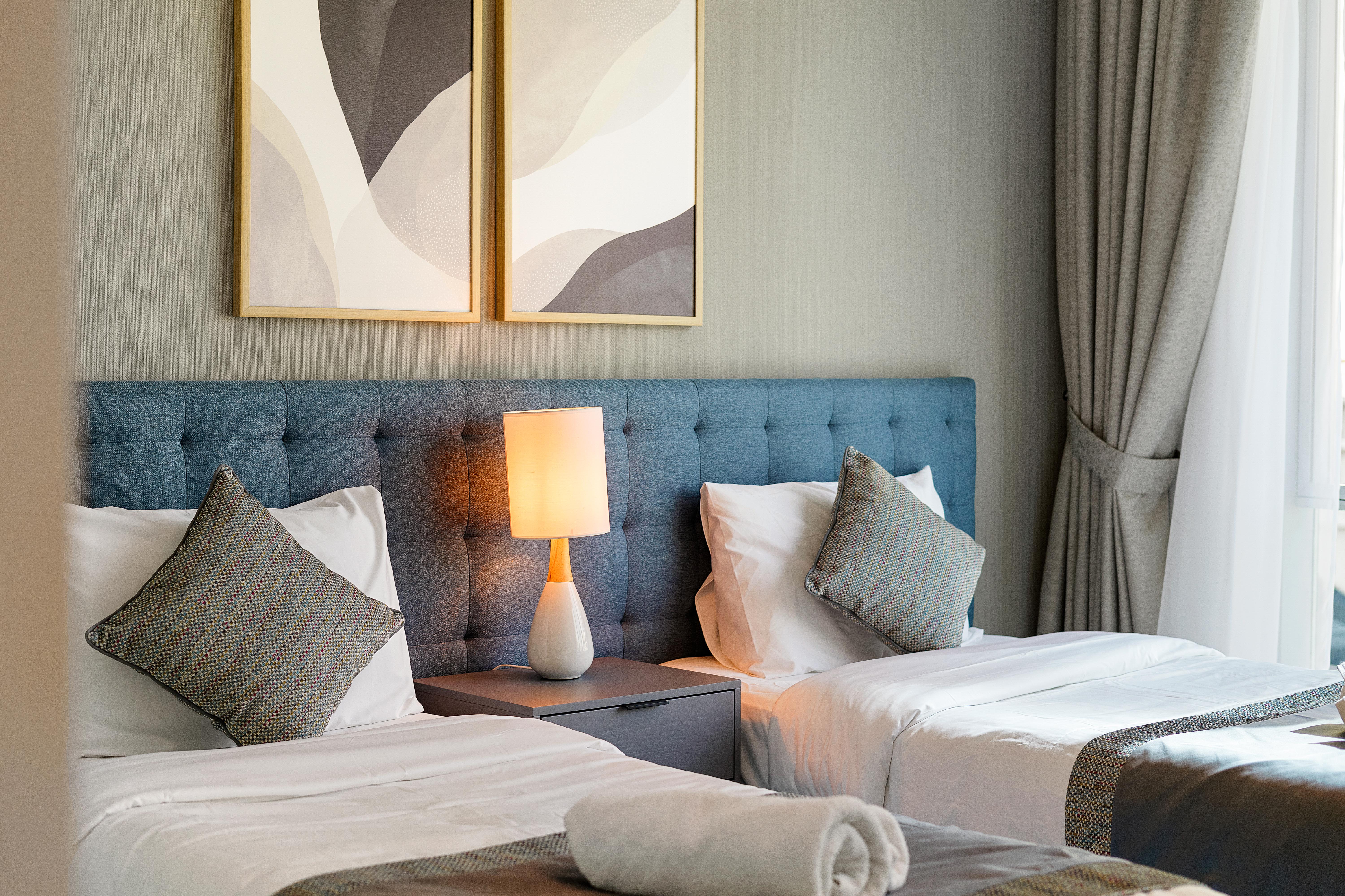 A living room with a white armchair, a coffee table with decor, and potted plants.