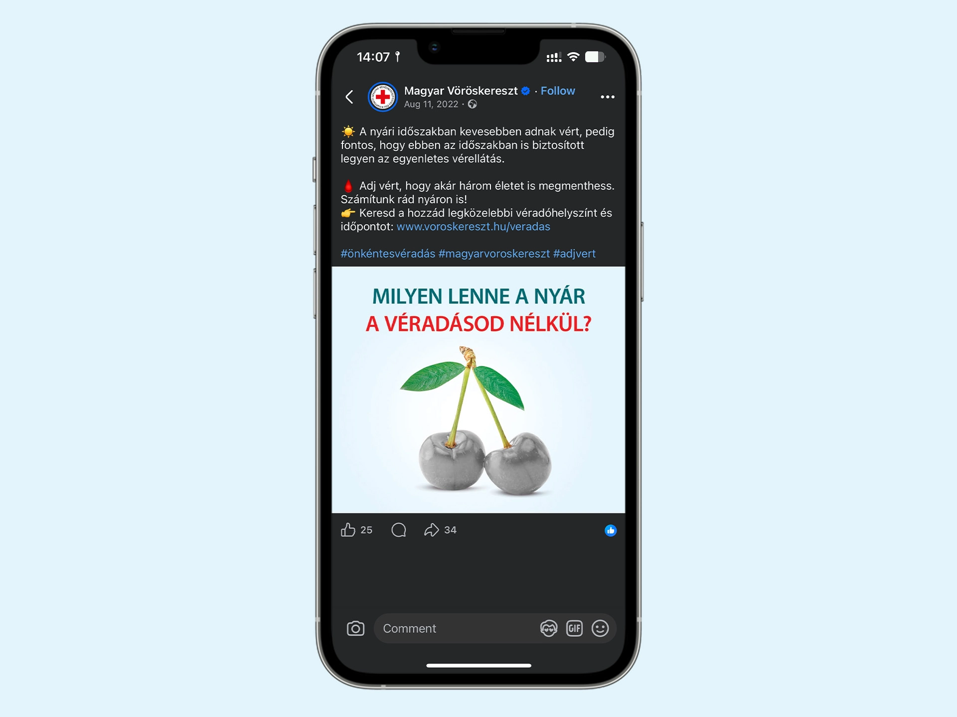 A Magyar Vöröskereszt véradásra hívó Facebook-posztja mobilon, szürke cseresznyével