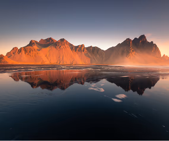A mountain range reflecting in the water.