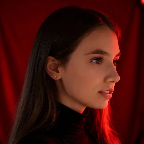 AI-generated image of a young woman with long straight brown hair, wearing a black turtleneck, illuminated by red light against a red background.