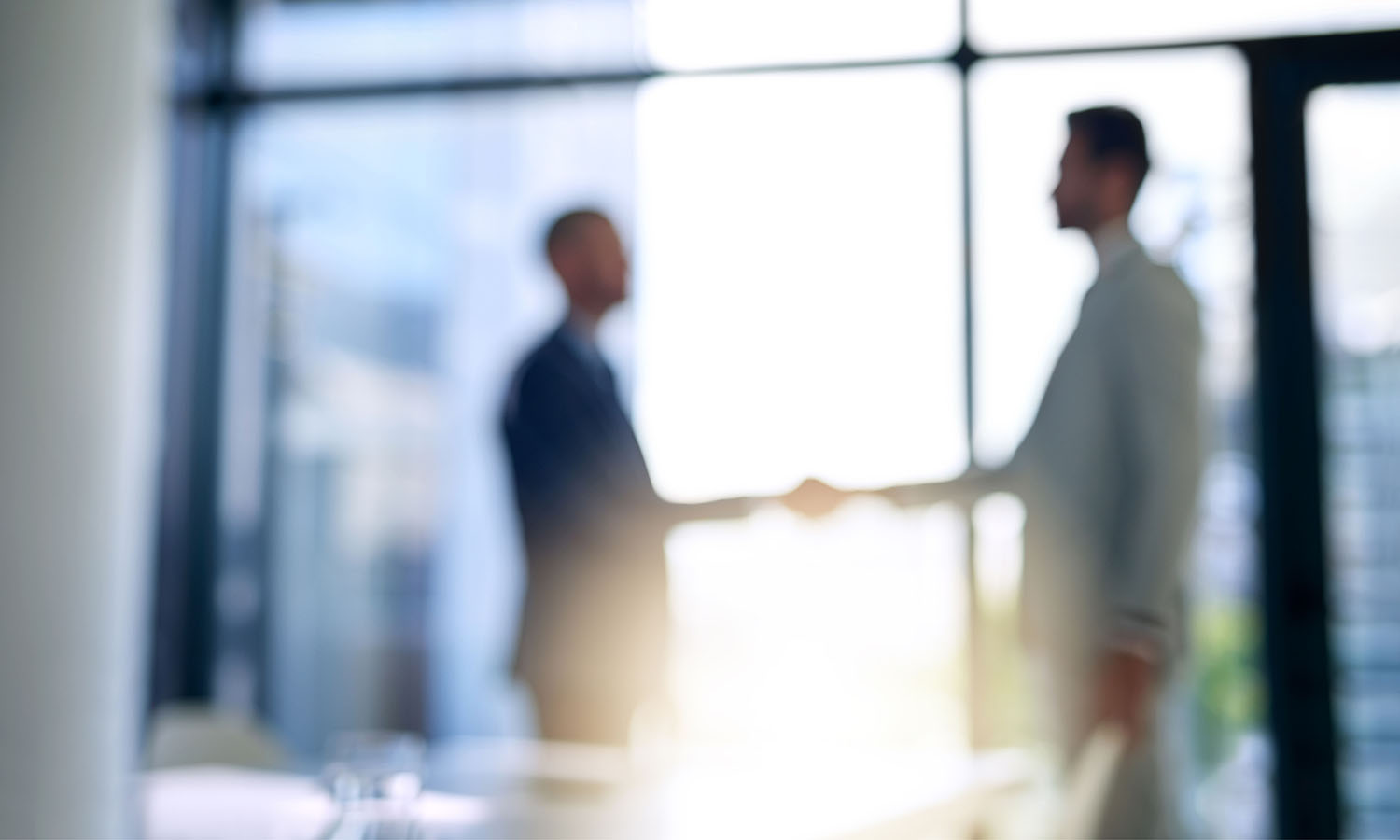 Potential employee meeting with hiring manager in office setting to discuss possible employment and relocation.