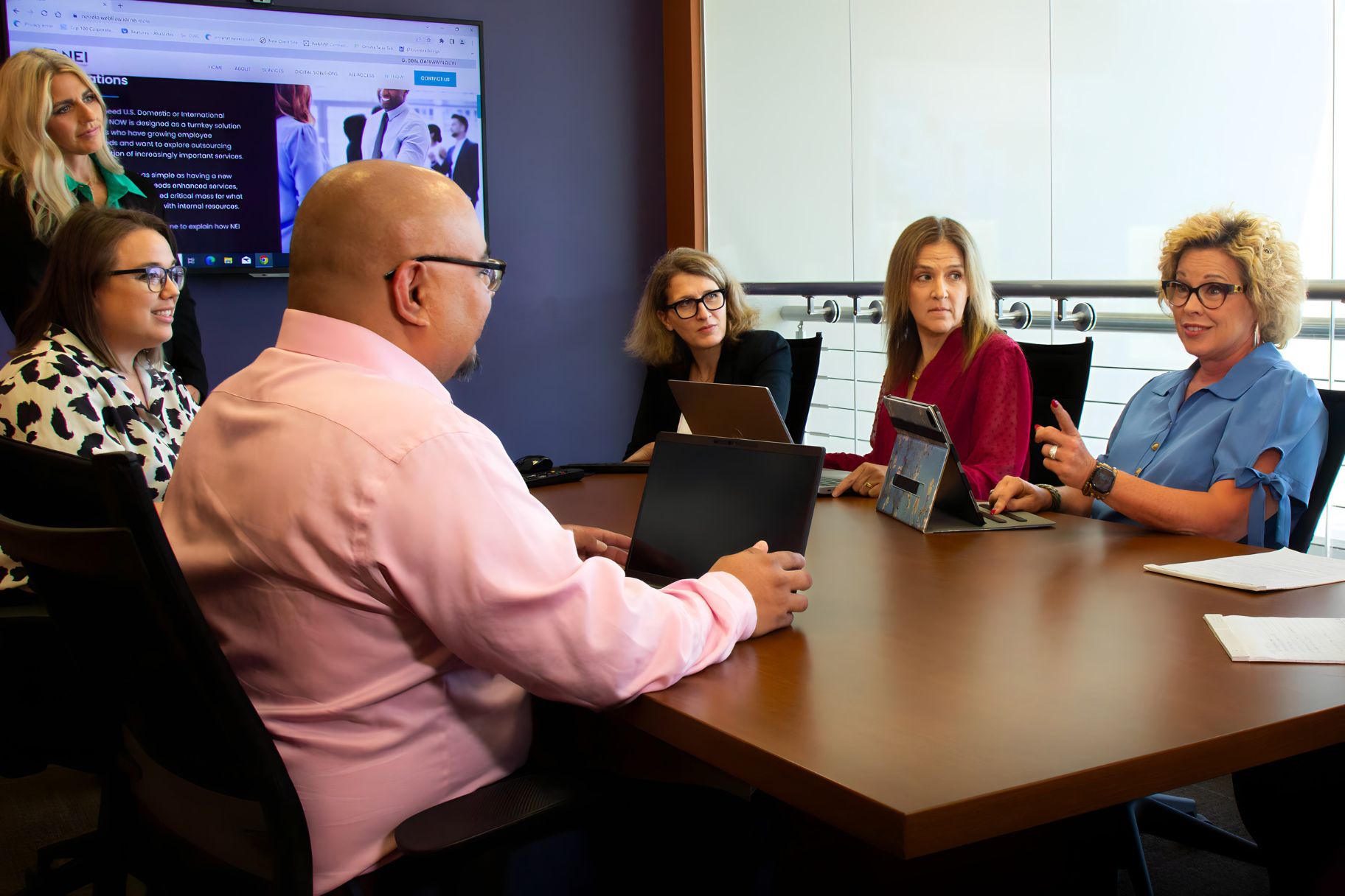 Mobility Operations team in conference room in discussion.